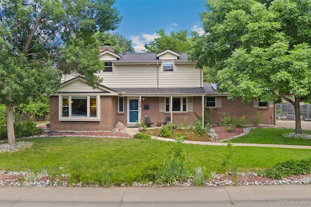 6906 S Sycamore St, Littleton, CO 80120 - traditional home with a front lawn, brick siding, and a chimney