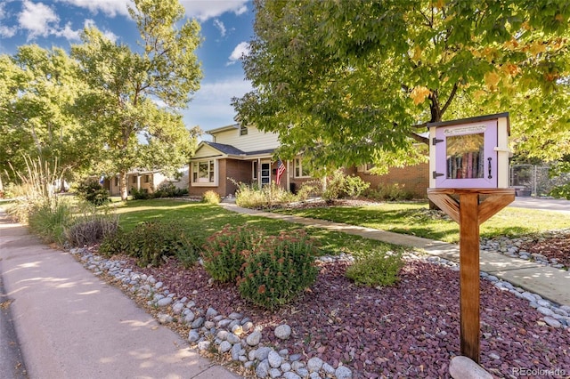 6906 S Sycamore St, Littleton, CO 80120 - view of property hidden behind natural elements with a front yard and brick siding