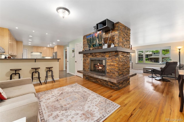 6906 S Sycamore St, Littleton, CO 80120 - living area with light wood-style floors, a fireplace, and recessed lighting