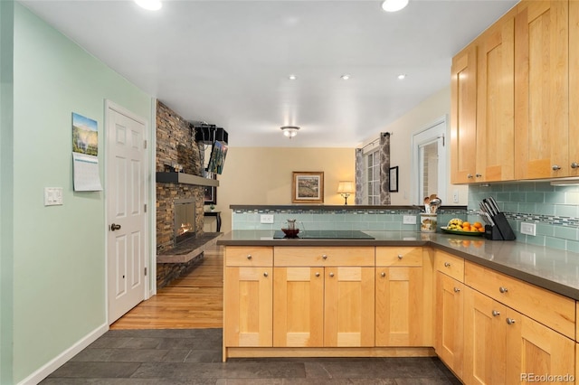 6906 S Sycamore St, Littleton, CO 80120 - kitchen with a peninsula, light brown cabinets, decorative backsplash, black electric stovetop, and recessed lighting
