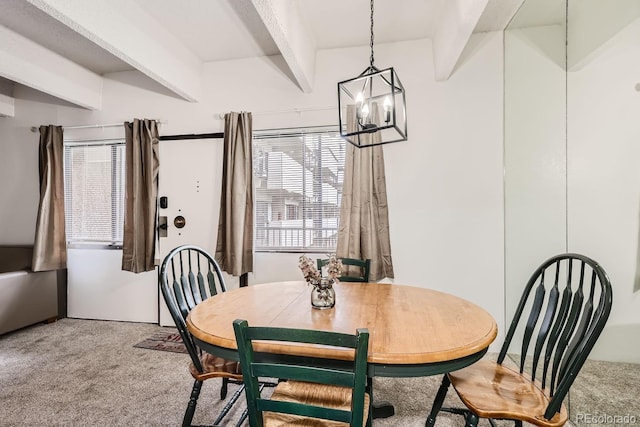 dining area featuring beamed ceiling, a chandelier, and carpet floors