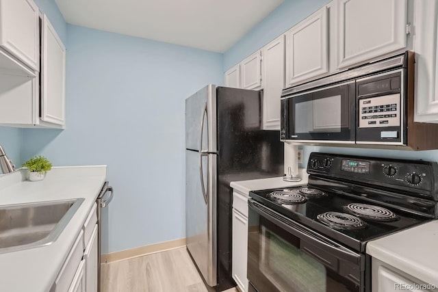 kitchen featuring dishwasher, white cabinetry, black electric range oven, sink, and light wood-type flooring