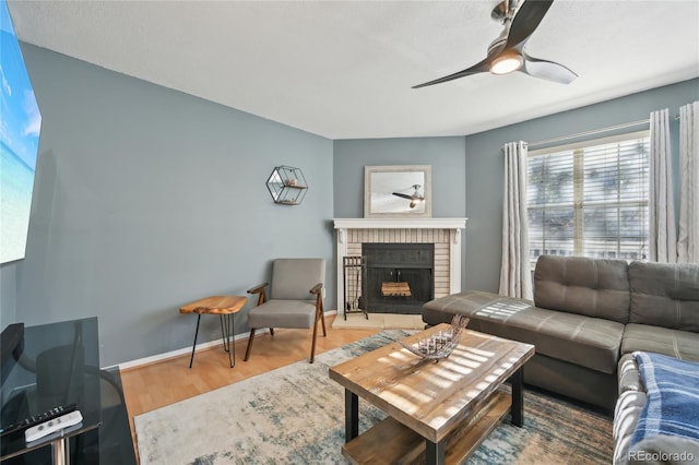 12655 E Pacific Cir Unit C, Aurora, CO 80014 - living room featuring wood finished floors, ceiling fan, and a brick fireplace