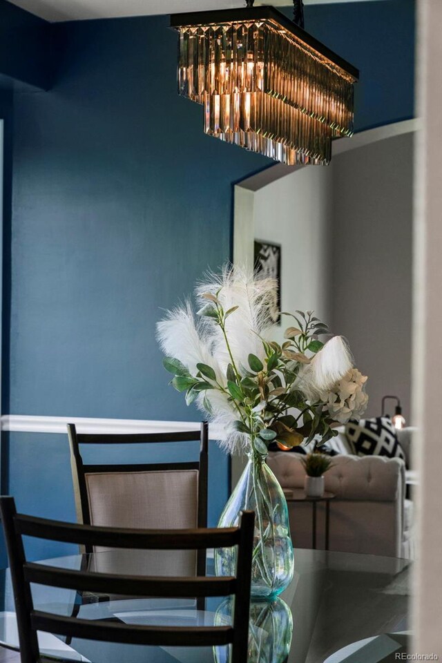 7119 S Riviera St, Aurora, CO 80016 - dining area view of a chandelier and stucco siding