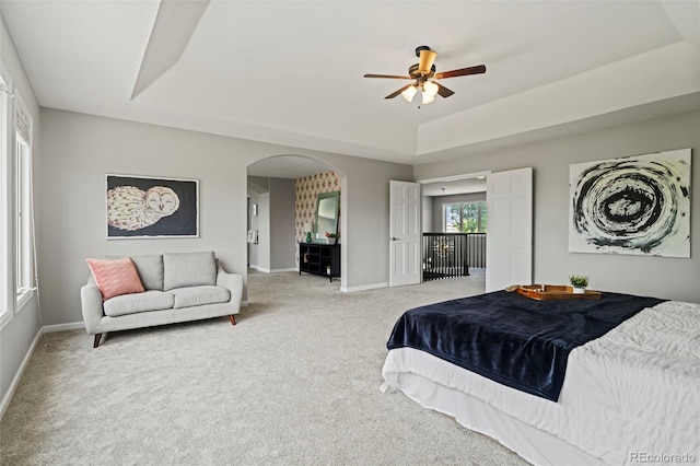 7119 S Riviera St, Aurora, CO 80016 - bedroom with a raised ceiling, light carpet, arched walkways, and a ceiling fan