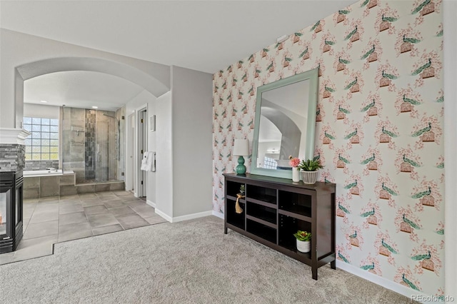 7119 S Riviera St, Aurora, CO 80016 - corridor with arched walkways, wallpapered walls, and carpet floors
