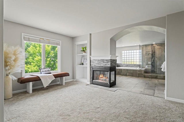 7119 S Riviera St, Aurora, CO 80016 - sitting room featuring arched walkways, carpet flooring, a fireplace, and recessed lighting