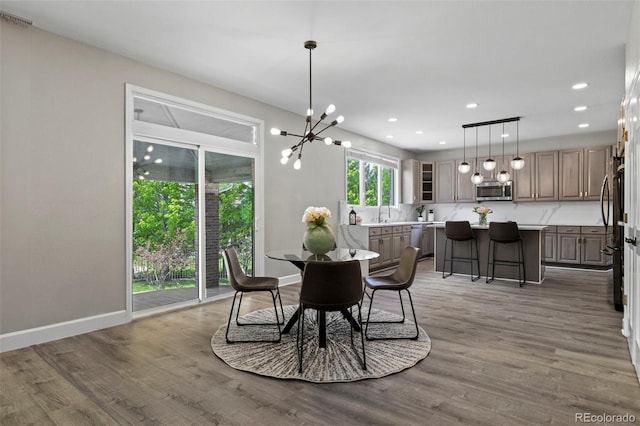 7119 S Riviera St, Aurora, CO 80016 - dining room featuring a chandelier, wood finished floors, and recessed lighting