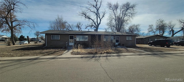 view of front of property featuring crawl space and brick siding