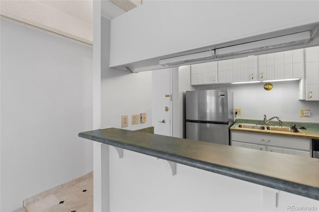 1265 N Race St Unit 603, Denver, CO 80206 - kitchen featuring freestanding refrigerator, white cabinetry, a kitchen breakfast bar, open shelves, and tile patterned flooring