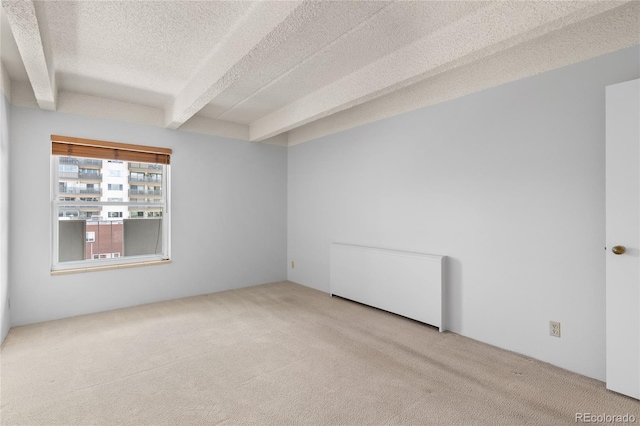 1265 N Race St Unit 603, Denver, CO 80206 - unfurnished room featuring carpet flooring, beam ceiling, and a textured ceiling