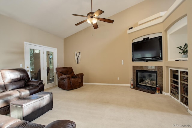 living room with ceiling fan, light colored carpet, and lofted ceiling