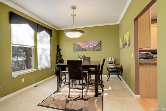 carpeted dining room with crown molding