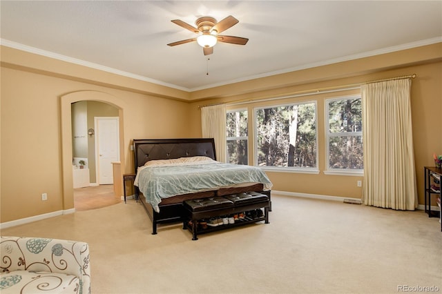 carpeted bedroom featuring ceiling fan and ornamental molding