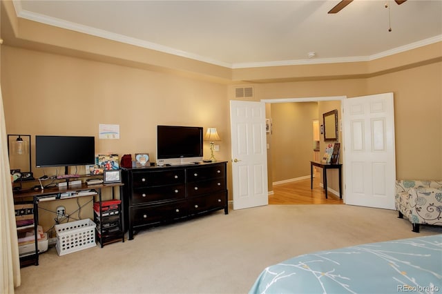 carpeted bedroom with ceiling fan and crown molding