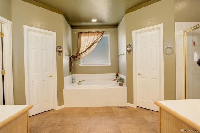 bathroom with plus walk in shower, a textured ceiling, and vanity