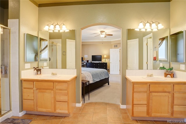 bathroom featuring ceiling fan, tile patterned flooring, crown molding, vanity, and a shower with shower door