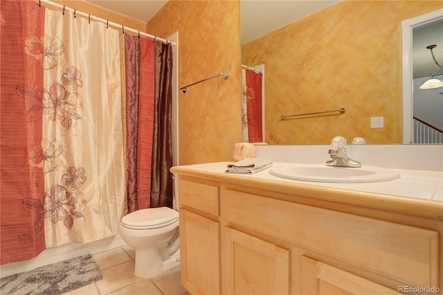 bathroom featuring tile patterned flooring, vanity, and toilet