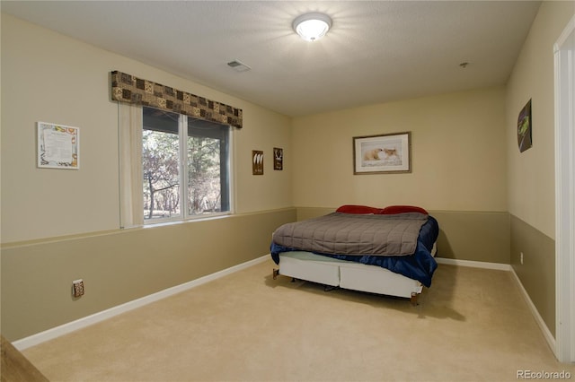 bedroom featuring light colored carpet