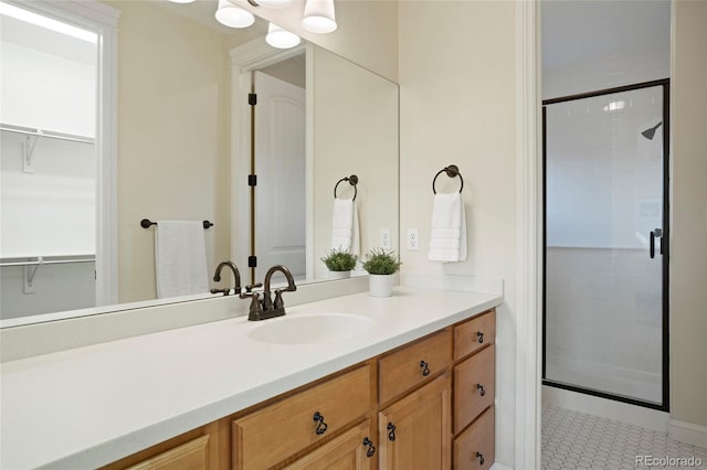 bathroom featuring tile patterned flooring, vanity, and a shower with shower door