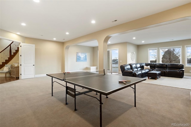 recreation room featuring light carpet