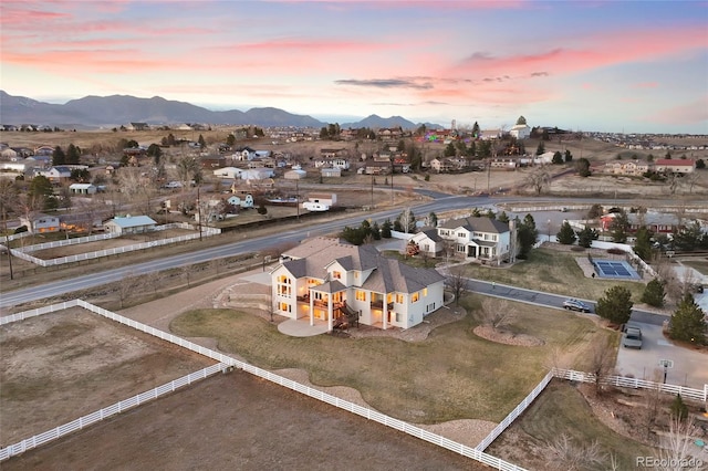 aerial view at dusk featuring a mountain view