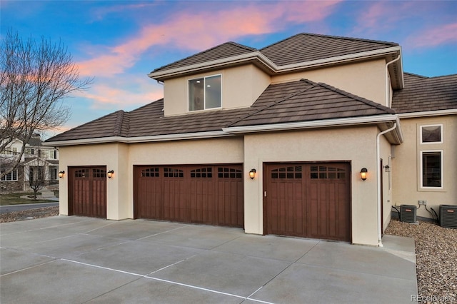 exterior space with a garage and central air condition unit