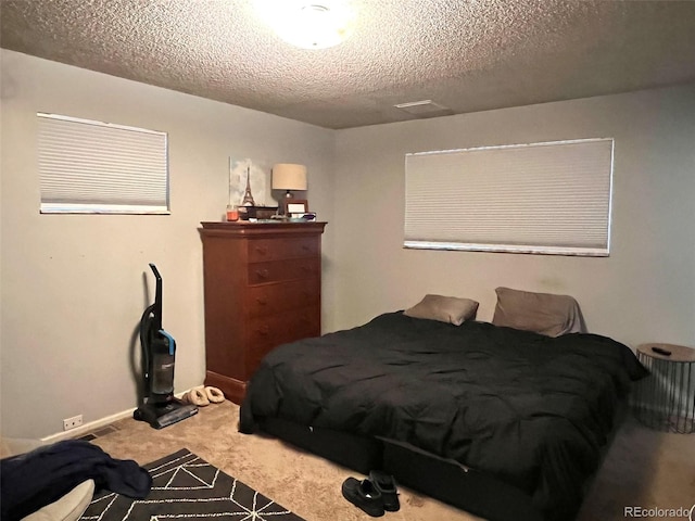 carpeted bedroom featuring a textured ceiling