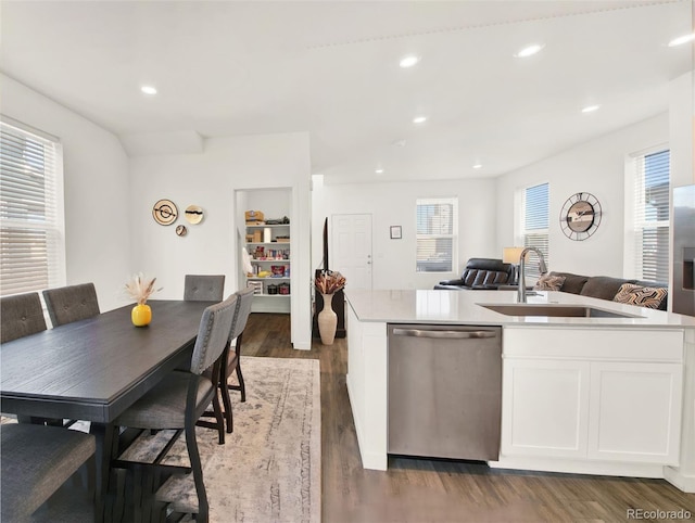 kitchen featuring dark hardwood / wood-style flooring, dishwasher, an island with sink, and sink