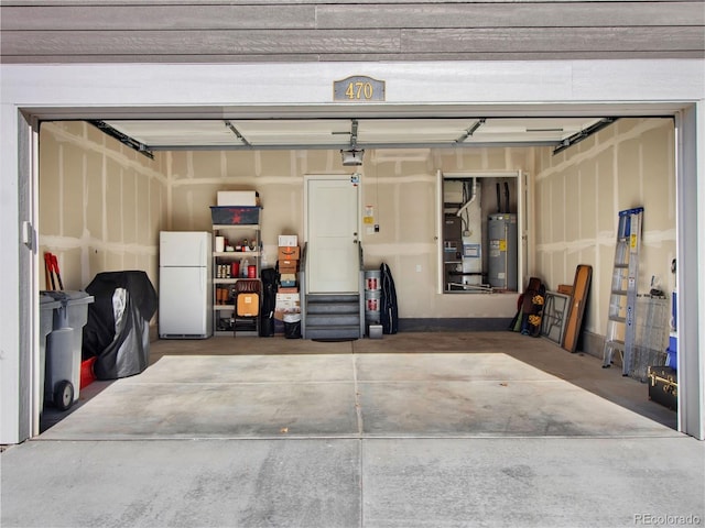 garage featuring white fridge and water heater