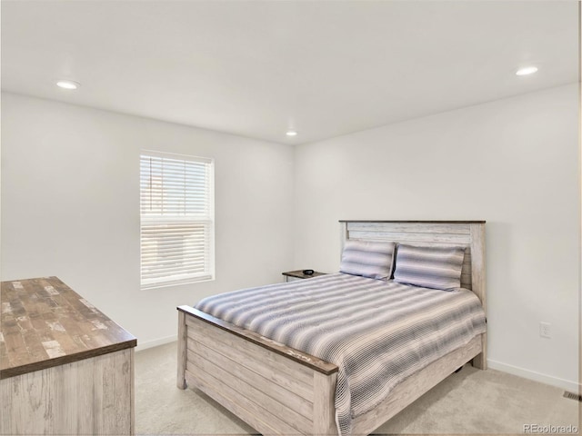 bedroom featuring light colored carpet