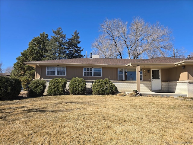 ranch-style house featuring brick siding, a porch, and a front lawn