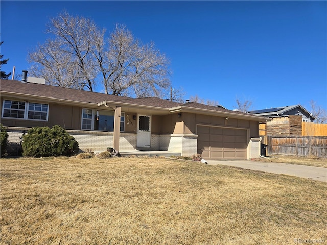 single story home with a front lawn, fence, concrete driveway, a garage, and brick siding