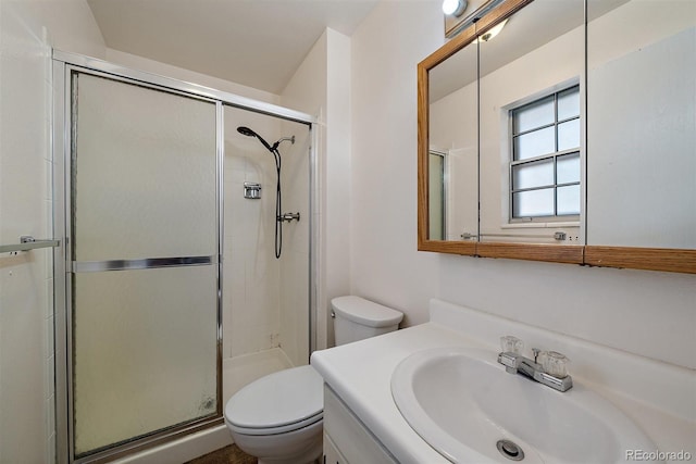 full bath featuring toilet, a stall shower, and vanity