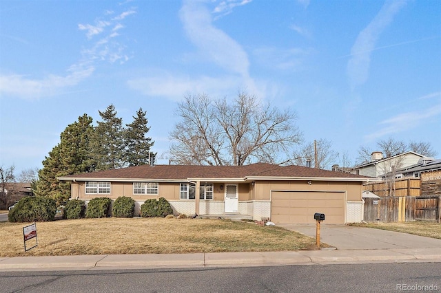 single story home with brick siding, a front lawn, fence, a garage, and driveway