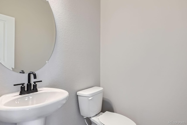 bathroom with toilet and sink