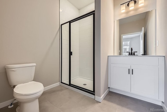 bathroom with vanity, tile patterned floors, toilet, and walk in shower