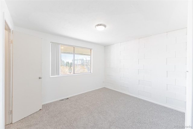 spare room featuring visible vents and carpet floors