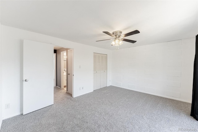 unfurnished bedroom featuring a closet, carpet floors, and ceiling fan