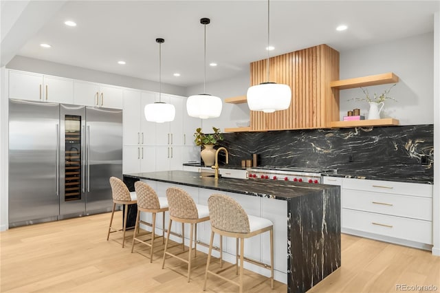 1001 S Adams St, Denver, CO 80209 - kitchen with high end refrigerator, open shelves, a sink, light wood-type flooring, and recessed lighting