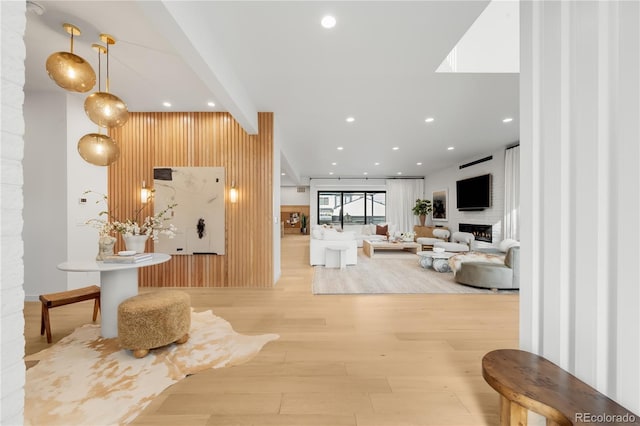 1001 S Adams St, Denver, CO 80209 - entrance foyer featuring wood finished floors, a fireplace, recessed lighting, wood walls, and an accent wall