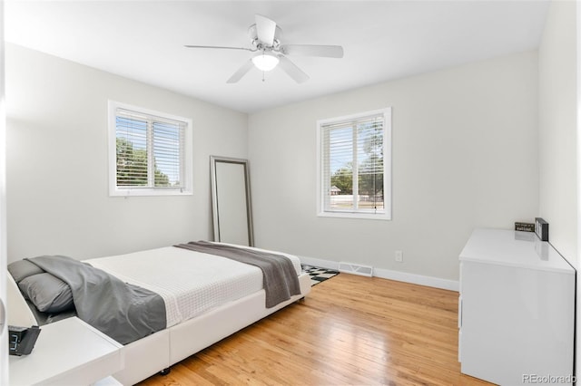 995 Ironton St, Aurora, CO 80010 - bedroom featuring multiple windows, light wood finished floors, and a ceiling fan