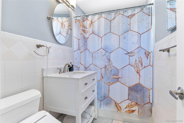 995 Ironton St, Aurora, CO 80010 - full bath with tile walls, vanity, a shower with curtain, and wainscoting