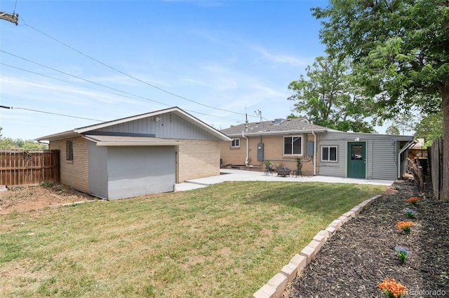 995 Ironton St, Aurora, CO 80010 - back of house featuring brick siding, a patio, and an outbuilding