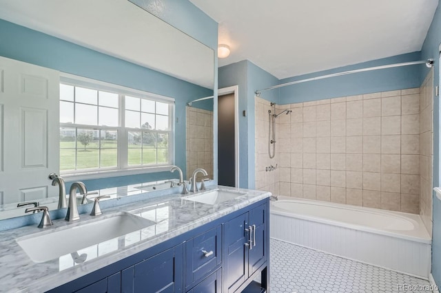 full bathroom featuring a sink, double vanity, and washtub / shower combination