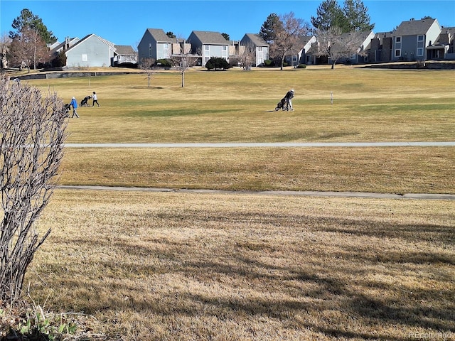 view of home's community featuring a lawn and a residential view