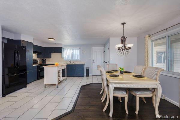 dining area with sink and a chandelier