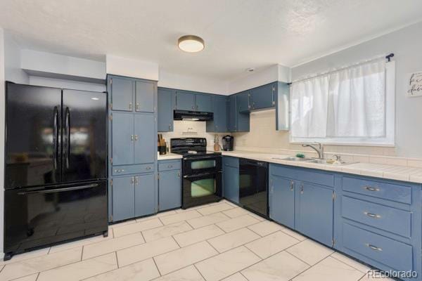 kitchen featuring blue cabinetry, sink, and black appliances