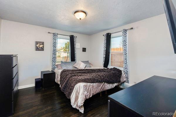 bedroom with dark wood-type flooring and a textured ceiling