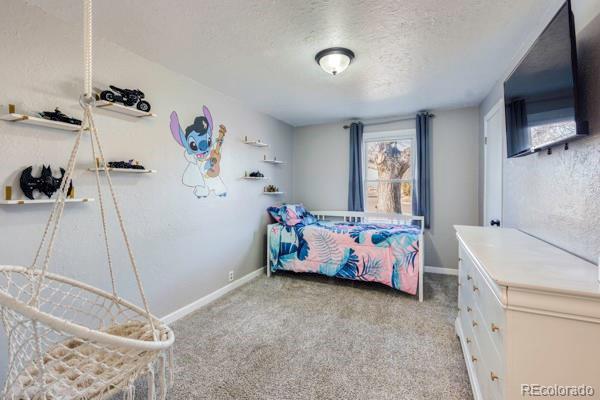 carpeted bedroom with a textured ceiling